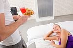 Lady On Bed Man Serving Breakfast Stock Photo