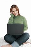 Lady Using Laptop And Phone Stock Photo