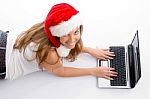 Laying Young Female With Christmas Hat And Laptop Stock Photo