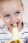 Little Boy Eating Banana Stock Photo