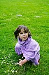 Little Girl Playing On Green Grass Stock Photo