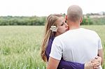 Loving Couple Standing In The Field Stock Photo