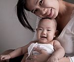 Loving Mother Holding Baby Stock Photo