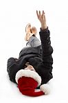 Lying Female Wearing Christmas Hat And Counting Fingers Stock Photo