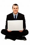 Male Executive With Laptop Sitting On The Floor Stock Photo