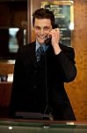 Male Receptionist Talking Phone Stock Photo