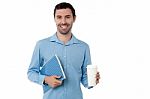 Man Holding Notebook And Beverage Stock Photo