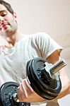 Man Lifting Dumbbell In Gym Stock Photo