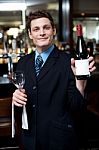 Man Posing With A Bottle Of Wine Stock Photo