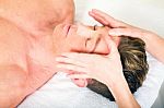 Man Receiving Face Massage Stock Photo