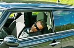 Man Sleeps In A Car Stock Photo