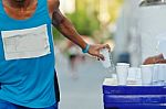 Marathon Racer Holing Cup Of Water