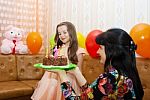 Mom Gives Daughter A Birthday Cake Stock Photo