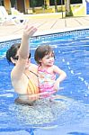 Mother And Baby In Swimming Pool Stock Photo