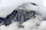 Moutains Peak Through Clouds Stock Photo