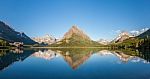 Mt Wilbur And Reflection At Swiftcurrent Lake In Glacier Nationa Stock Photo