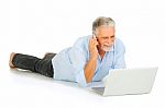 Old Man With Laptop Lying Stock Photo