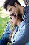 Outdoor Portrait Of Young Caucasian Couple At The Park Stock Photo