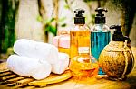 Pastel Spa Oils In Bottles On Wooden Table And Nature Background Stock Photo