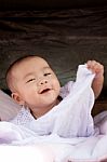 Portrait Close Up Face Of Asian Baby Lying On Bed And Playing Wi Stock Photo