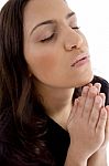 Portrait Of Praying Young Woman Stock Photo