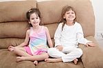 Portrait Of Two Girls In The Sofa Stock Photo