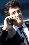 Portrait Of Young Businessman Talking With Smartphone Stock Photo