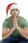 Praying Man Wearing Santa Hat Stock Photo