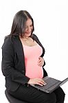 Pregnant Businesswoman Working At Laptop Stock Photo