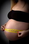 Pregnant Lady Measuring Her Tummy Stock Photo