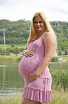 Pregnant Woman By Lake Stock Photo
