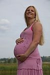 Pregnant Woman Relaxing Outdoors Stock Photo