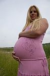 Pregnant Woman Relaxing Outdoors Stock Photo