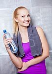 Pretty Blonde Woman Smiling After Fitness Training Drinking Wate Stock Photo