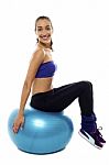 Pretty Lady Sitting On Big Blue Exercise Ball Stock Photo
