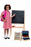 Pretty Schoolgirl Pointing At Chalkboard Stock Photo
