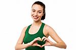 Pretty Teenager Making Heart Symbol With Hands Stock Photo