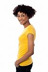 Pretty Woman Wearing Yellow Top And Jeans Stock Photo