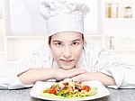 Pretty Young Chef And Hers Plate Of A Delicious Salad In Kitchen Stock Photo