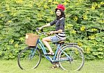 Pretty Young Woman With Bicycle In A Park Smiling Stock Photo