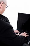 Rear View Of Business Man Working In Laptop Stock Photo