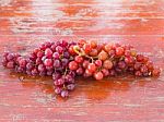 Red Grapes On The Wooden Table  .  Stock Photo