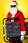 Santa Claus Carrying Chair To Relax Stock Photo