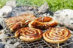 Sausages On Grill Outdoor Stock Photo