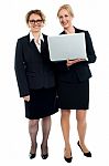 Senior Businesswomen Posing With Laptop Stock Photo