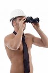 Side View Of Muscular Architect Looking Through Binocular Stock Photo