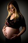 Side View Of Smiling Pregnant Woman Stock Photo