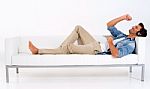 Single Guy Relaxing On Couch Stock Photo
