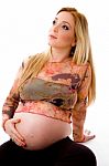 Sitting Pregnant Woman Looking Up Stock Photo