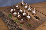 Skewers Of Meat On Wooden Cutting Board Stock Photo
